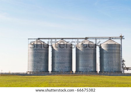 four farm grain silos for agriculture Royalty-Free Stock Photo #66675382