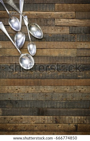 Vintage antique spoons on old wooden background flat lay food blog mockup, copy space