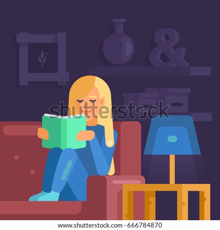The girl is sitting on the sofa with the book. She is passionately reading. She bent her knees. 