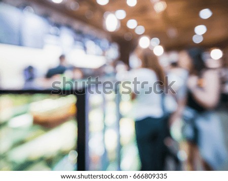 Abstract blur of cashier in shopping mall with employee and customer