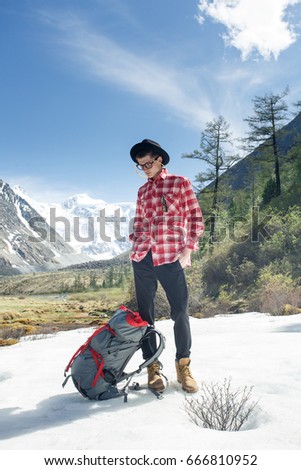 Traveller adventure hiking mountain with backpack and hat. Belukha mountain in Altay. Summer photo