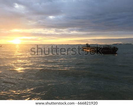 Behind boat is sunset at the sea and sky have many cloud