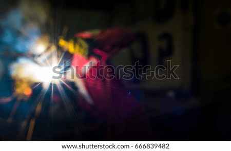 Blur image of an offshore welder working in his workshop with full personnel protective equipment for background use