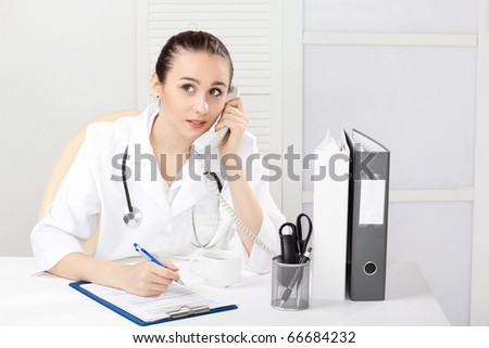 Female medical doctor working with a microscope