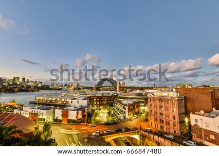 Stunning HDR night shot of the night skyline in Sydney, New South Wales, Australia. Beautiful view of the Sydney Harbor bridge, North Sydney, Millers Point and Walsh Bay. Shortly after sunset. 