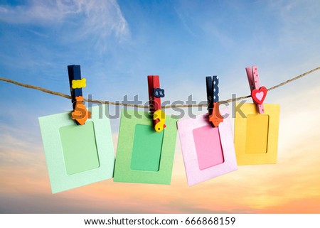 Photo Frame hanging on the rope with sky background.