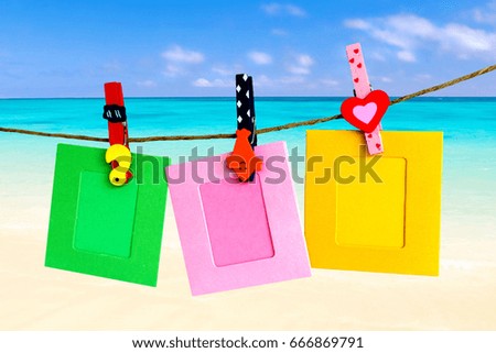 Photo Frame hanging on the rope with sky Sea beach background.