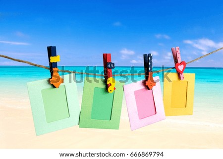 Photo Frame hanging on the rope with sky Sea beach background.