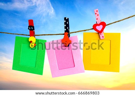 Photo Frame hanging on the rope with sky background.