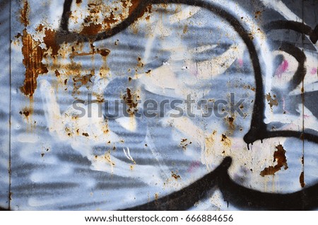 Detailed image of very old and aged color graffiti drawing on the wall. Background grunge street art picture