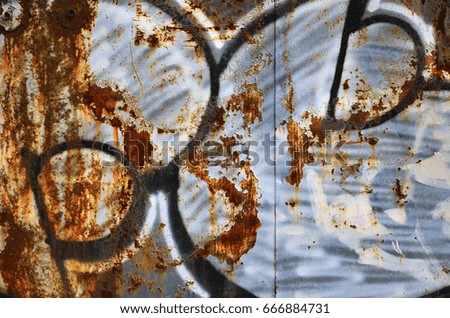 Detailed image of very old and aged color graffiti drawing on the wall. Background grunge street art picture