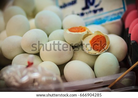 Salted duck eggs for sale in the fresh market. The preservation of duck eggs with salt. Yolk of salted eggs. Royalty-Free Stock Photo #666904285