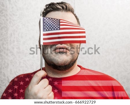 mini American flag covered face, adult man holding isolated on white wallpaper wall  background, 4 th of July, no face, eyes. unrecognizable person 