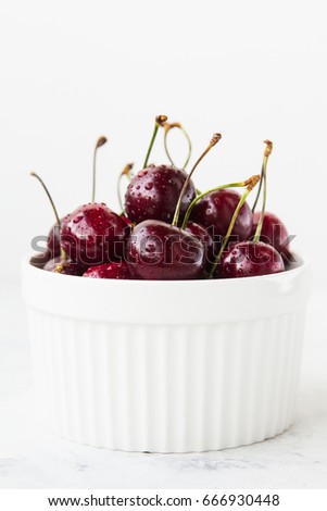 Cherry in a bowl on a white background