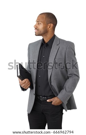 Portrait of elegant ethnic businessman with personal organizer, side view, cutout on white.