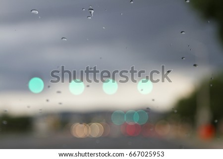 Rain on a Windshield with Blurry Scenery and Car Lights Extra Bokeh