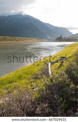 Snake River in the early morning under cumulus cloud sky in Alpine Wyoming USA