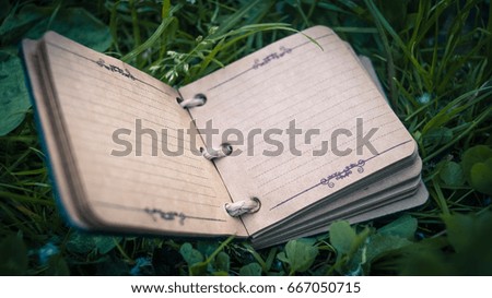 Vintage notebook on an atmospheric grass background