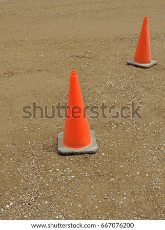 Orange traffic cones at a construction site dirt surface