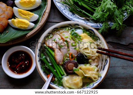 Homemade Vietnam food, egg noodle soup with wontons, colorful food ingredient for this eating as egg, pork, broth, shallot, bean sprout, agaric, vegetable Royalty-Free Stock Photo #667122925