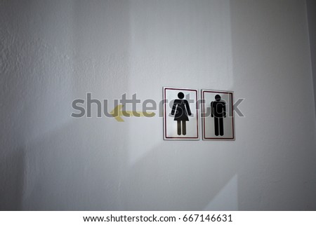 men and women toilet logo on the white wall.