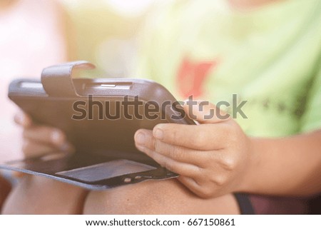 little boy holding a mobile phone.