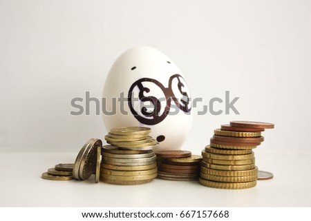 Business concept money. A surprised egg with coins. Photo for your design