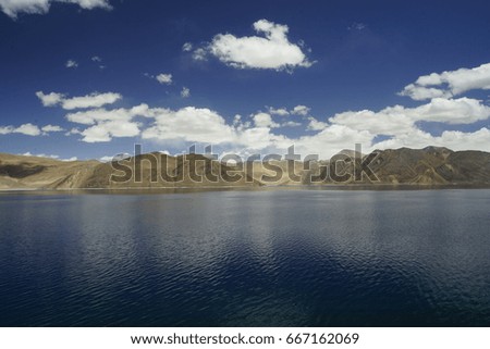 Pangong lake with sky blue reflection in water, deep blue sky and mountains background in Leh Ladakh, Jammu and Kashmir, North India
