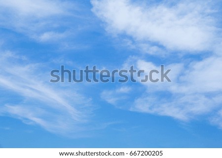 Bright sky with floating clouds