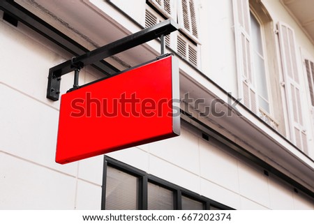 Red shop logo sign on the wall