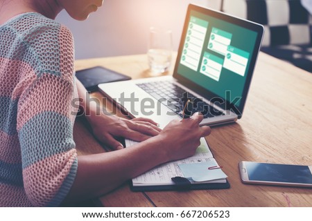 Businesswoman working with laptop, Writing something idea on notebook or check list in office Royalty-Free Stock Photo #667206523
