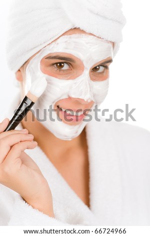 Teenager problem skin care - woman facial mask apply with brush