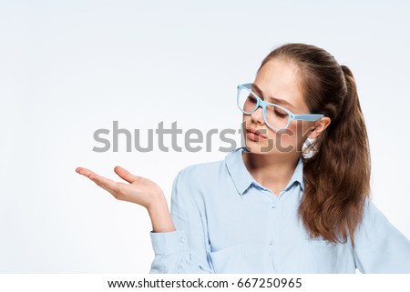 Woman points to an empty space in glasses                               