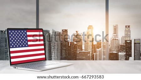 Independence Day on office laptop screen with panoramic sunset view of modern downtown skyscrapers at business district