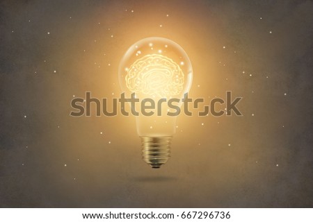 golden brain glowing inside of light bulb on paper texture background Royalty-Free Stock Photo #667296736