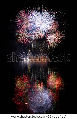 Firework. Beautiful colorful fireworks on the water surface with a clean black background. Fun festival and contest of Firefighters  Brno Dam - Czech Republic.