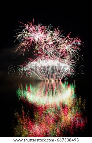 Firework. Beautiful colorful fireworks on the water surface with a clean black background. Fun festival and contest of Firefighters  Brno Dam - Czech Republic.