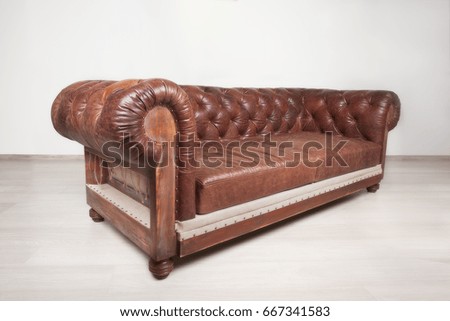 Brown leather sofa on grey background