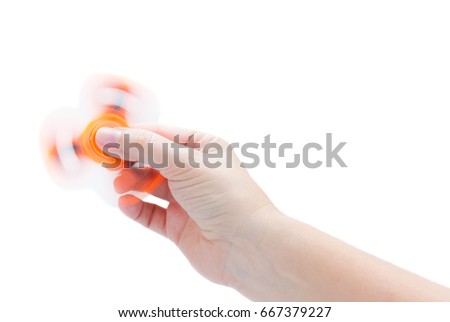 Hand holding spinning fidget spinner, popular relaxing toy, generic design isolated on white background