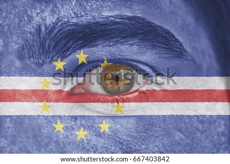 Human face and eye painted with flag of Cape Verde