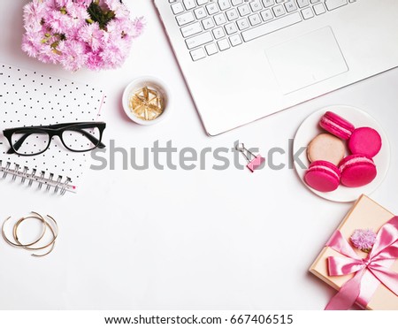 Beautiful woman's workplace. Laptop, flowers, glasses and other cute accessories. Royalty-Free Stock Photo #667406515