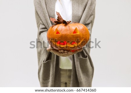 Girl holding Halloween pumpkin