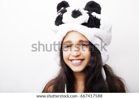 Portrait of a adorable girl in panda hat on white background.