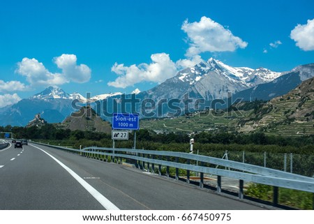 Road to Sion, Switzerland, in background Alps and Sion's castles on the hills