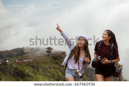 Asian women tourists were excited to see the mist on the mountain, she pointing