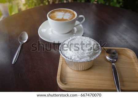 cake and  cup of coffee late art with space on wood background,vintage picture style