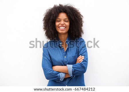 Portrait of beautiful positive african american woman standing with arms crossed Royalty-Free Stock Photo #667484212