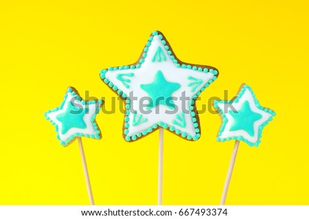 Topper. Homemade gingerbreads in the form of turquoise stars on the yellow background. Picture for a menu or a confectionery catalog. Invitation or greeting card.
