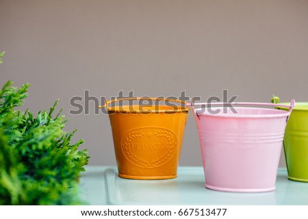 Bucket list concept. Three colorful buckets hanging on white wall