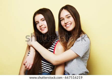 lifestyle and people concept: Two young girl friends standing 